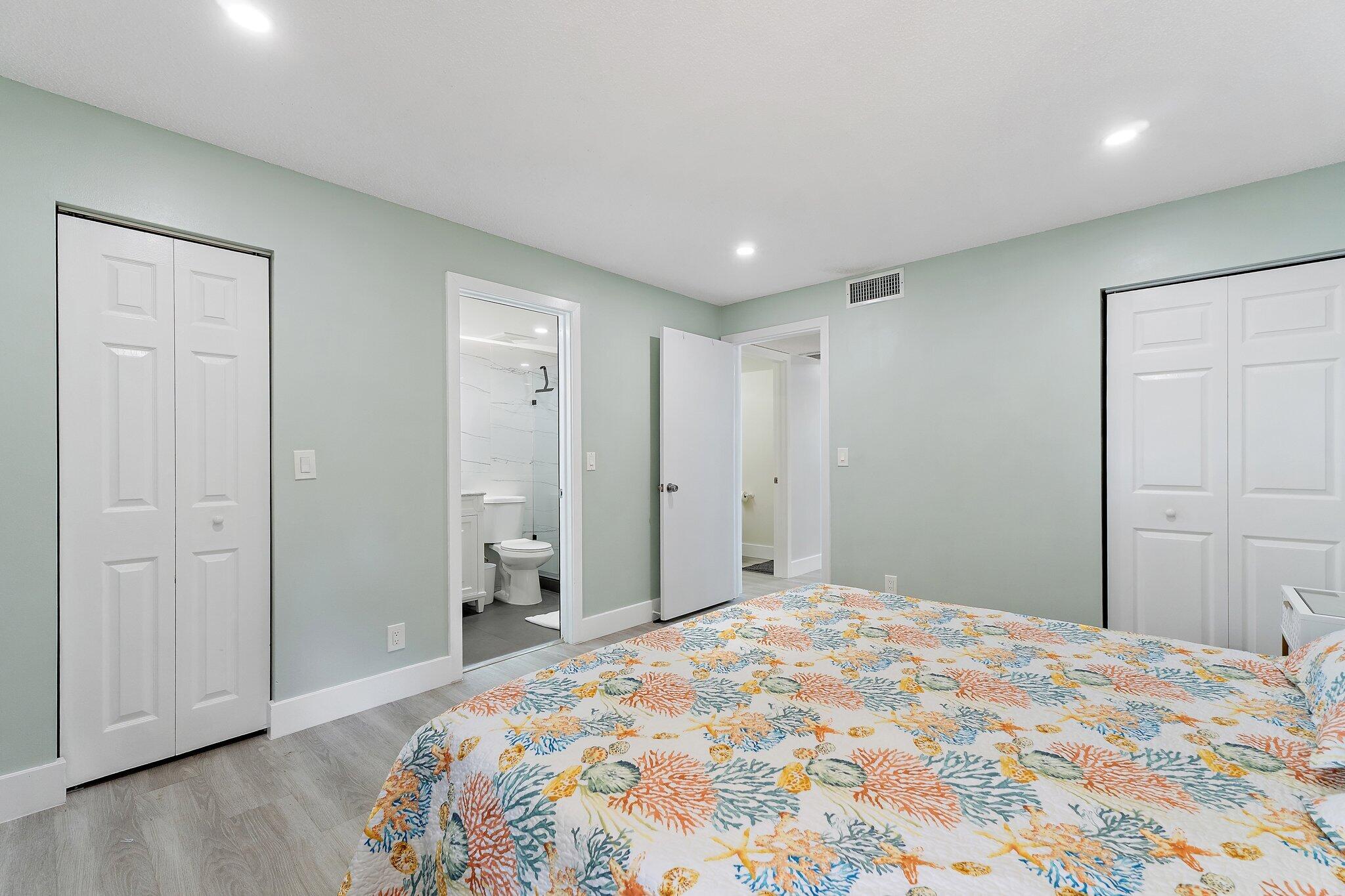 1605 Highway 1, Unit V2204 Jupiter, FL 33477 - Photo 23 of 36 a bedroom with a bed and a bathroom