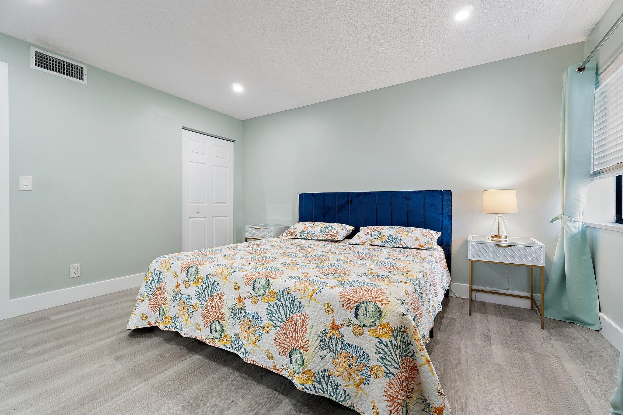 1605 Highway 1, Unit V2204 Jupiter, FL 33477 - Photo 24 of 36 a bedroom with a bed and a table