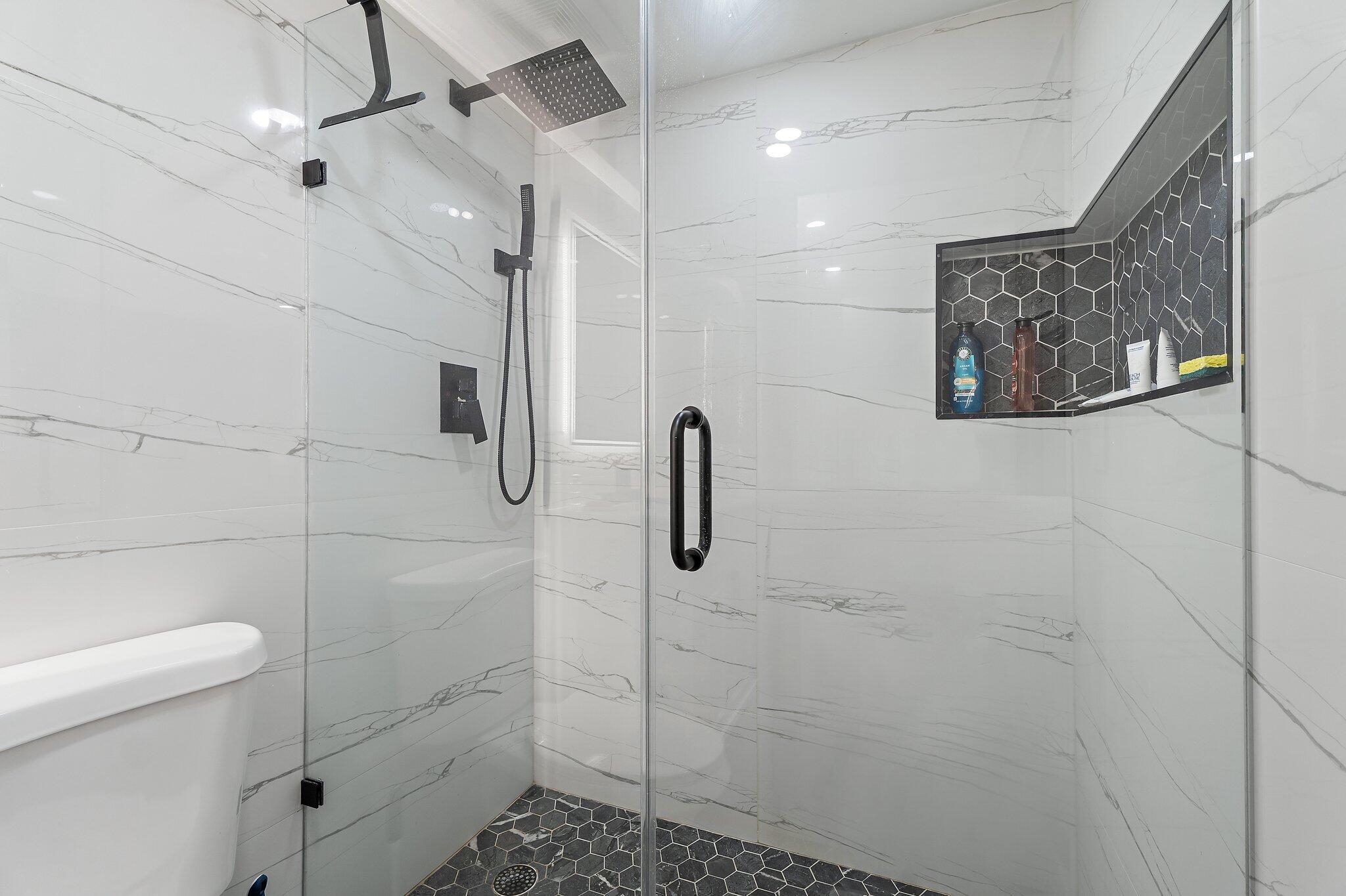 1605 Highway 1, Unit V2204 Jupiter, FL 33477 - Photo 26 of 36 a bathroom with a shower