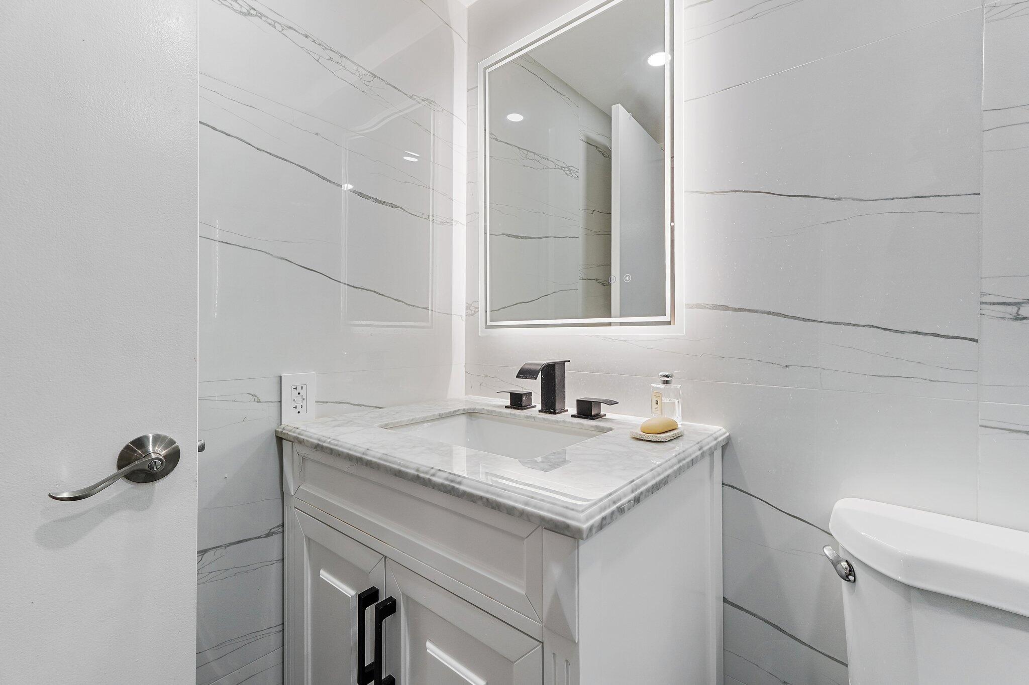 1605 Highway 1, Unit V2204 Jupiter, FL 33477 - Photo 27 of 36 a bathroom with a sink and vanity