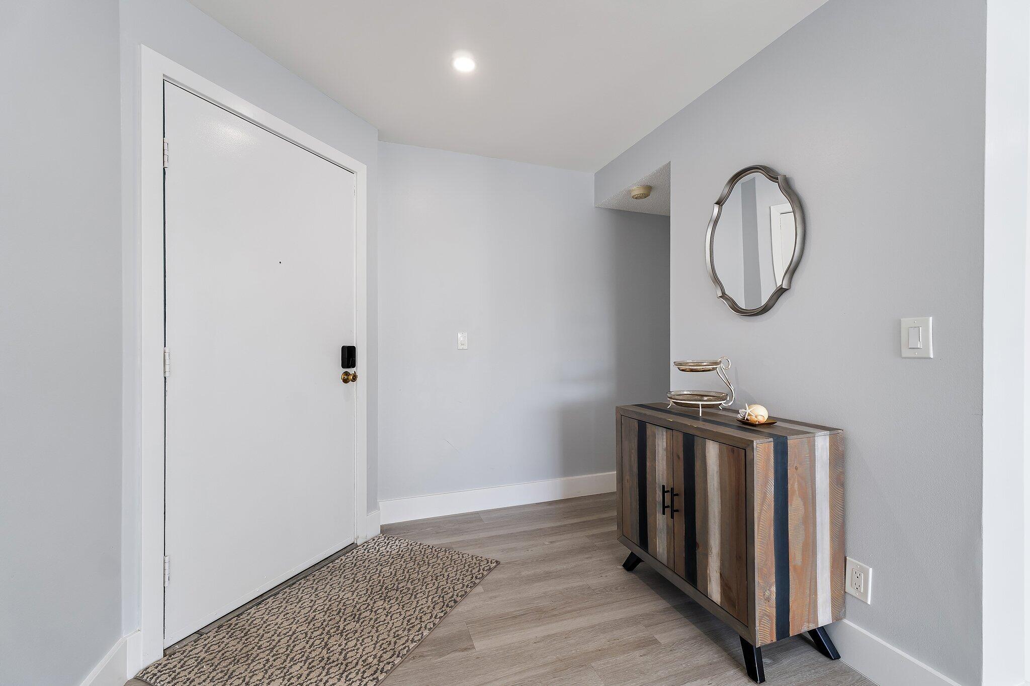 1605 Highway 1, Unit V2204 Jupiter, FL 33477 - Photo 5 of 36 a view of a room with wooden floor and white doors