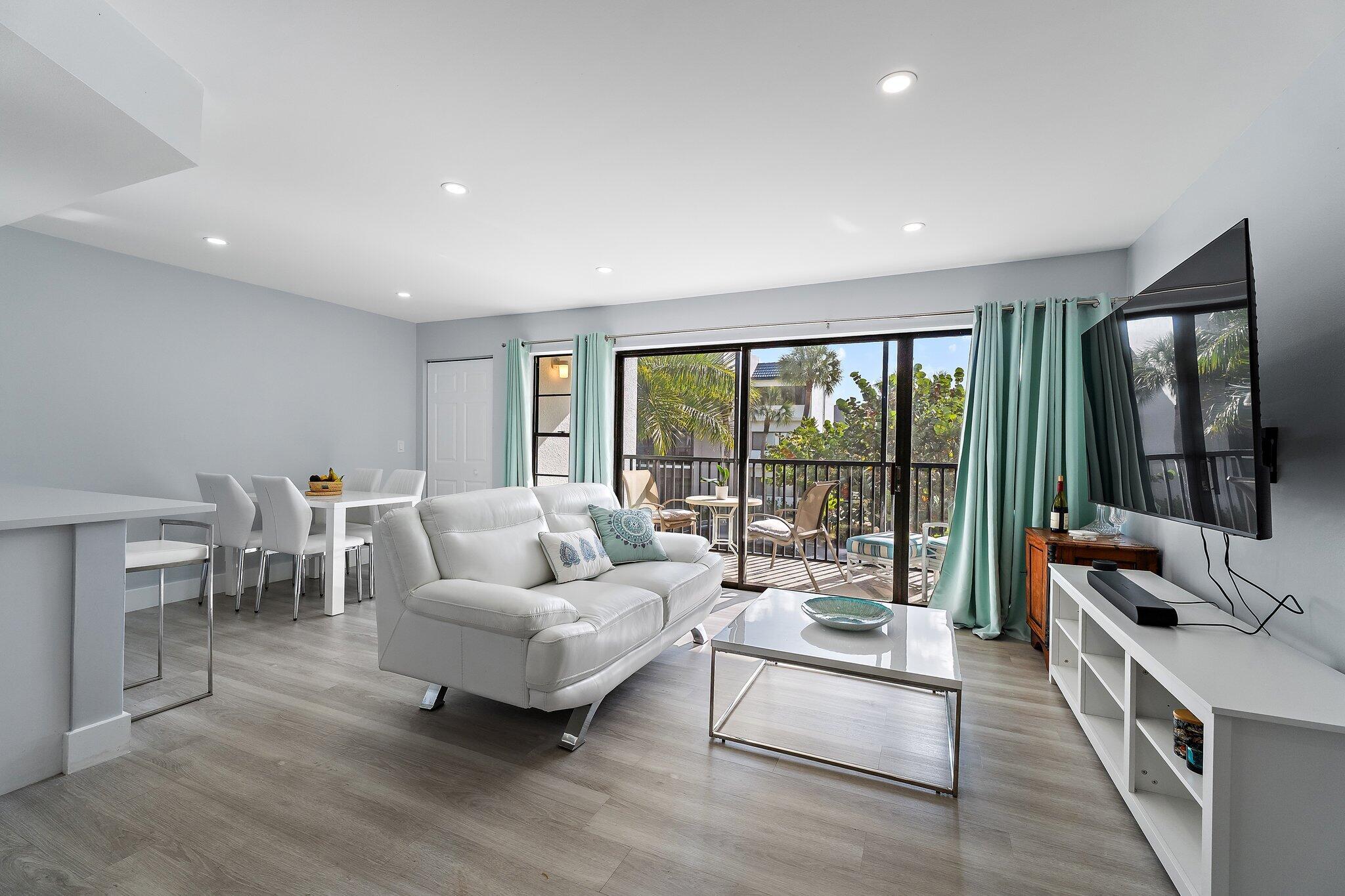 1605 Highway 1, Unit V2204 Jupiter, FL 33477 - Photo 6 of 36 a living room with furniture and a large window