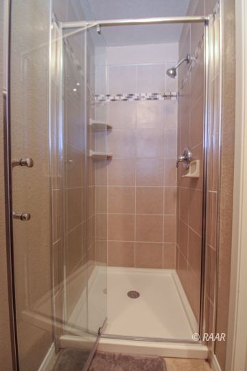 221 South Primrose Street Ridgecrest, CA 93555 - Photo 25 of 29 a bathroom with a shower and a glass door shower