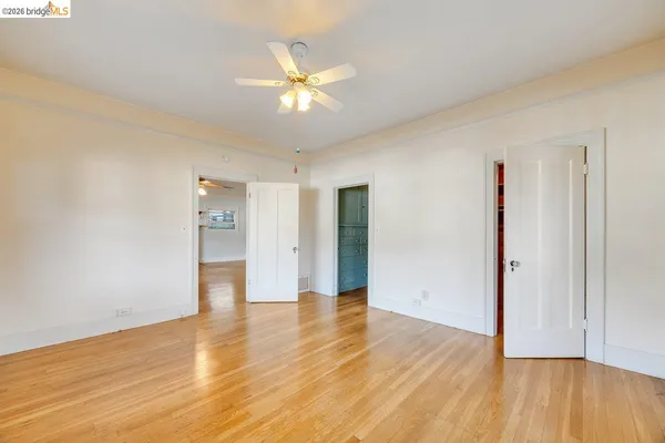 a view of an empty room with wooden floor