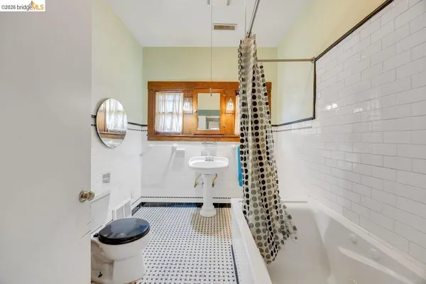 a bathroom with a bathtub toilet and a shower