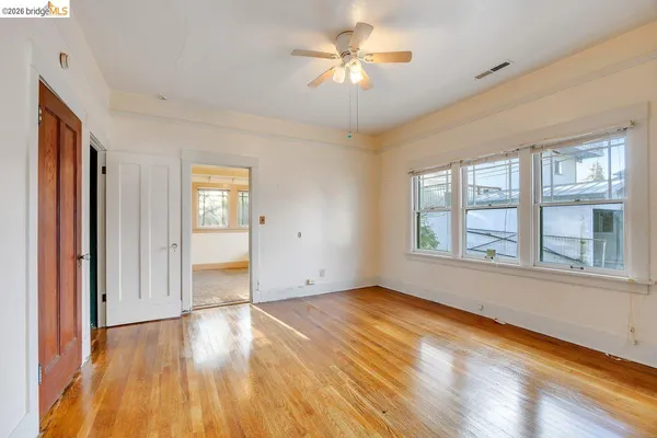 wooden floor in an empty room with a window