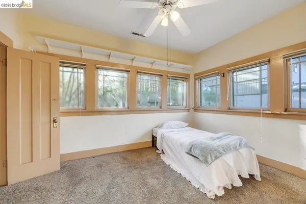 a bedroom with a bed and a large window
