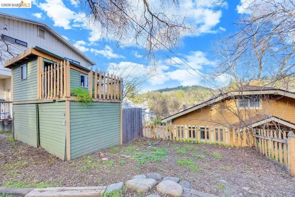 a view of a house with a yard and pathway