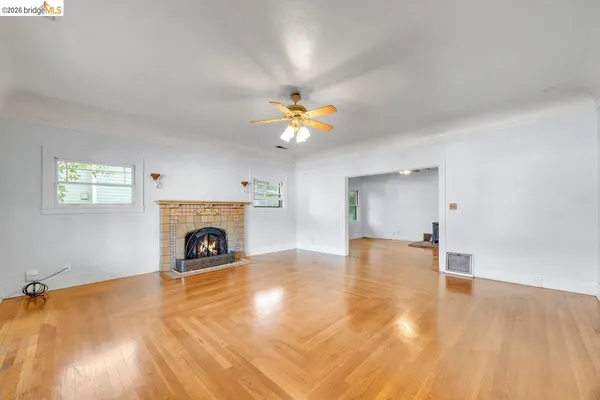 a view of an empty room with a fireplace and a window