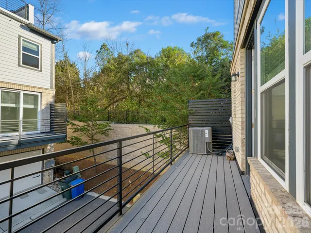 a view of a balcony with wooden floor and fence