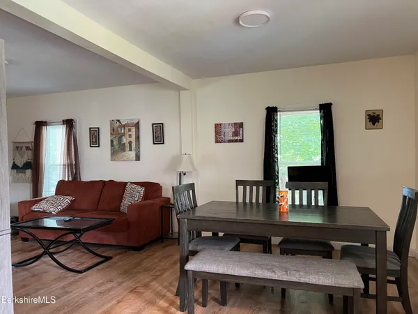 a living room with furniture a table and a window