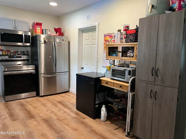 a kitchen with stainless steel appliances granite countertop a refrigerator sink and stove