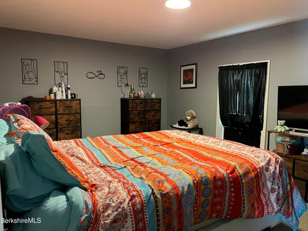 a bedroom with a bed and dresser