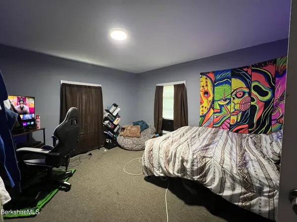 a view of a livingroom with furniture and a flat screen tv