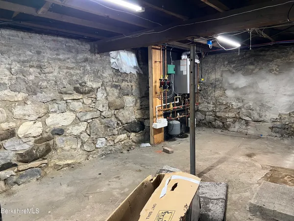 a room with water heater and wooden walls