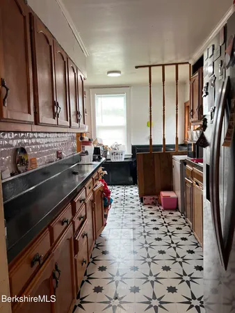 a kitchen with stainless steel appliances a sink stove top oven and cabinets