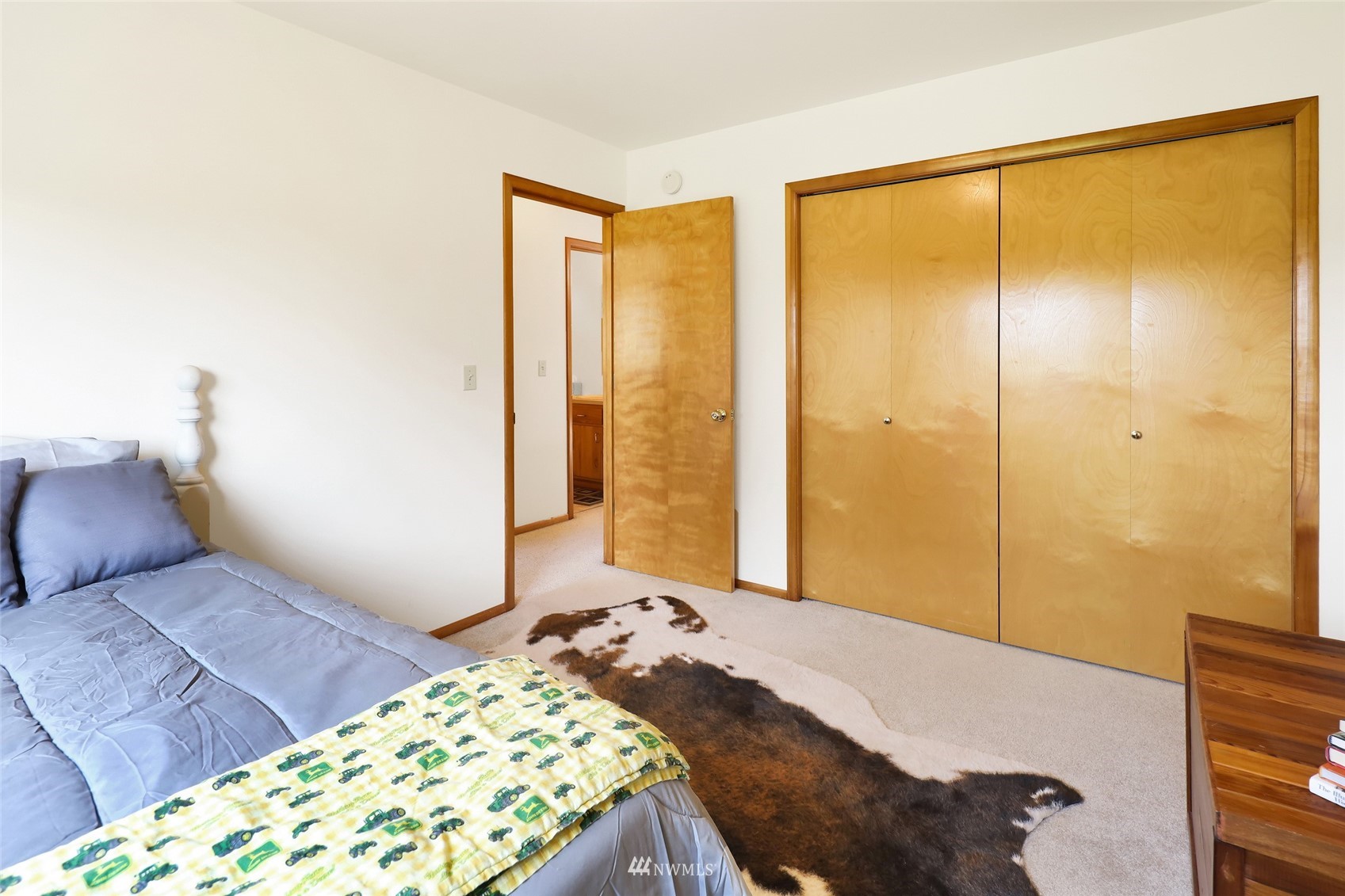 3938 Bowen Road Sumas, WA 98295 - Photo 14 of 34 a bedroom with a large bed and a chandelier