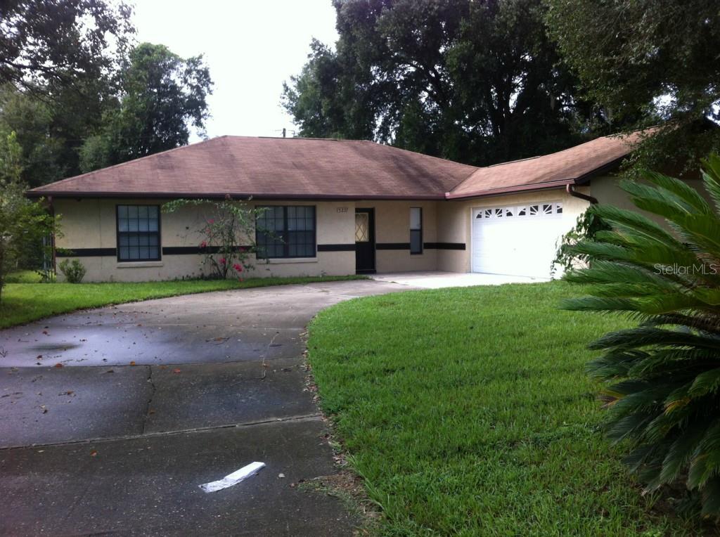 3227 Roland Drive Deltona, FL 32738 - Photo 1 of 1 a front view of a house with a yard