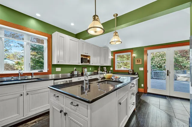 a kitchen with stainless steel appliances granite countertop a sink and a window