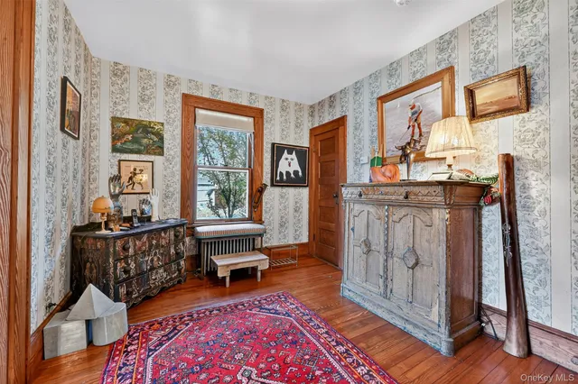 a living room with furniture a fireplace and a large window