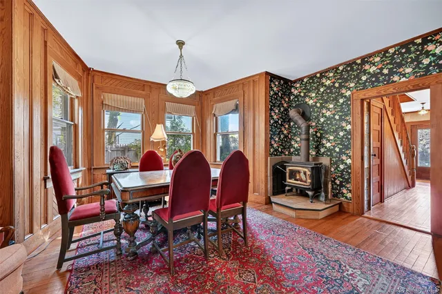 a dining room with furniture a chandelier and wooden floor