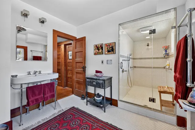 a living room with furniture and a mirror