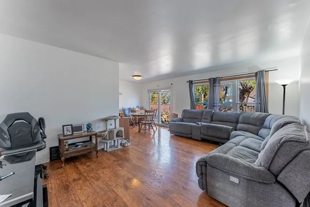 a living room with furniture a couch and wooden floor
