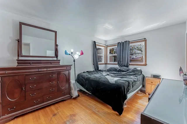 a bedroom with a bed and a dresser