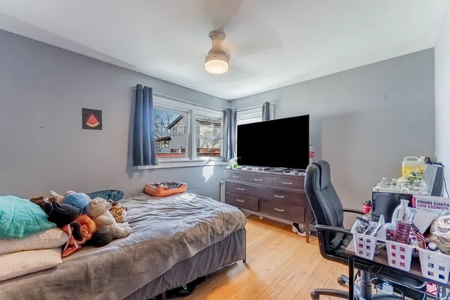 a bedroom with bed and a flat screen tv