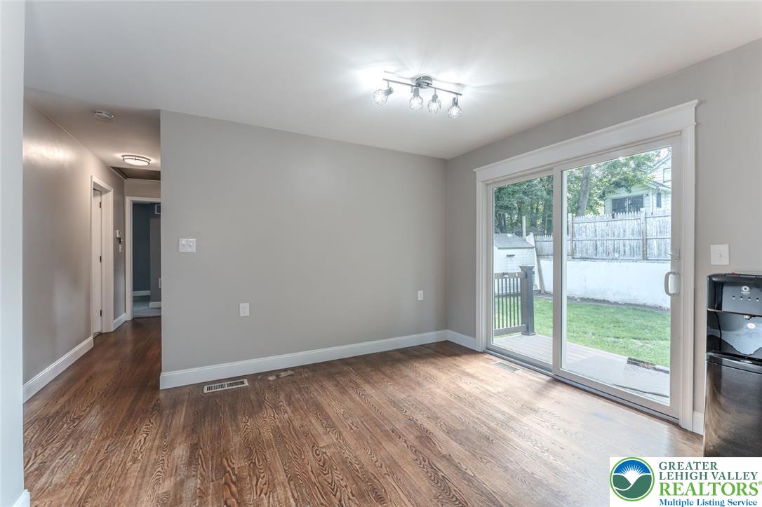 402 Maple Street Roseto, PA 18013 - Photo 12 of 39 Rich hardwood flooring complements smooth walls and a wide sliding glass door opening to the yard.