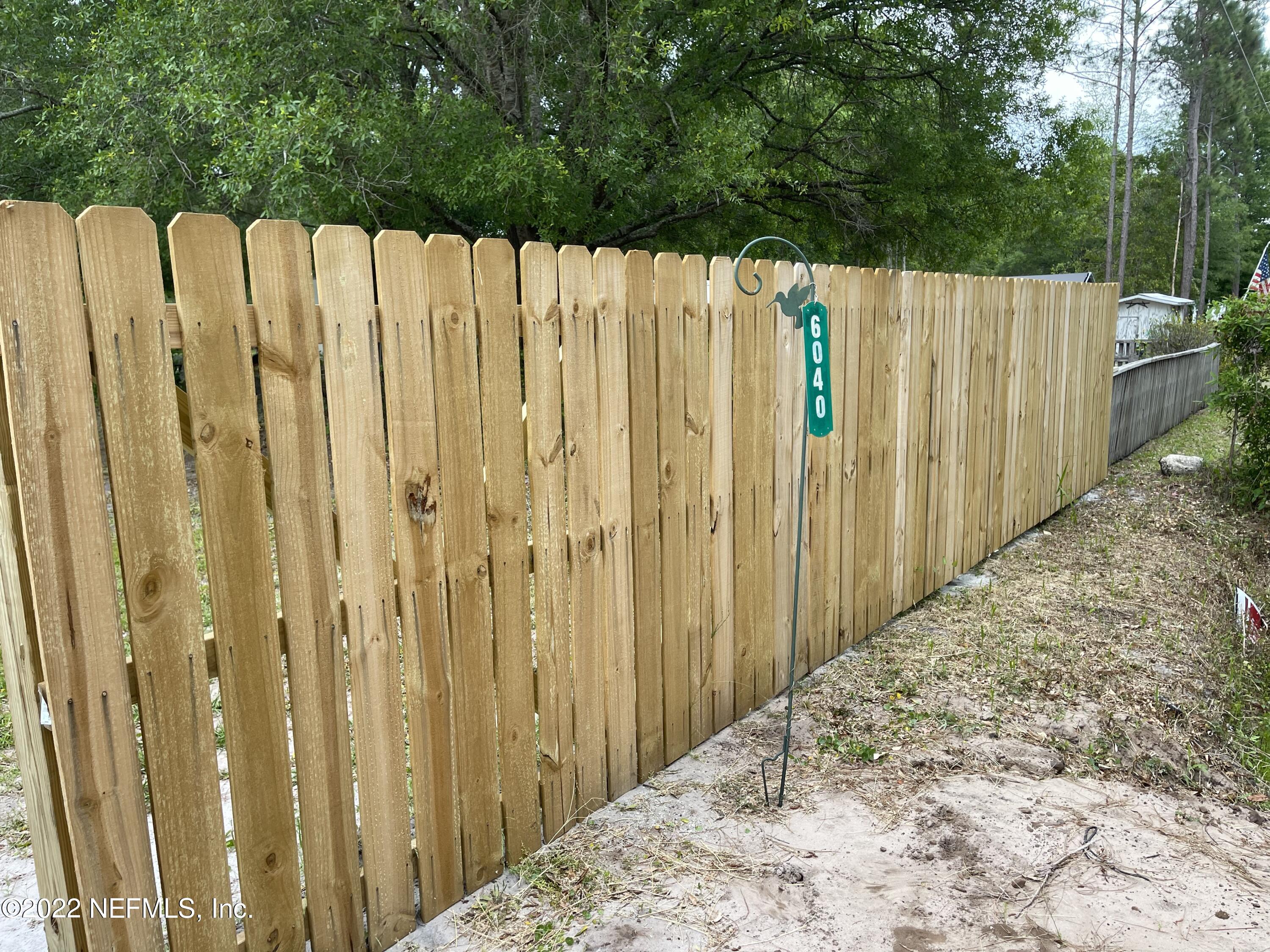 a view of a wooden fence