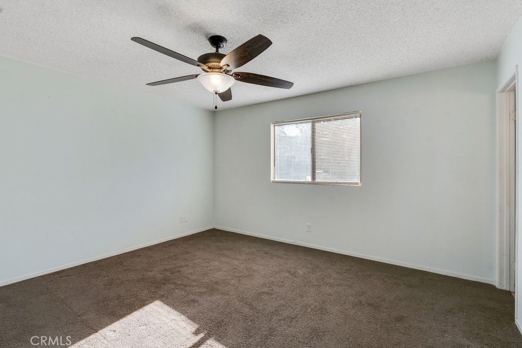 7365 Chase Hesperia, CA 92345 - Photo 11 of 21 an empty room with windows and fan