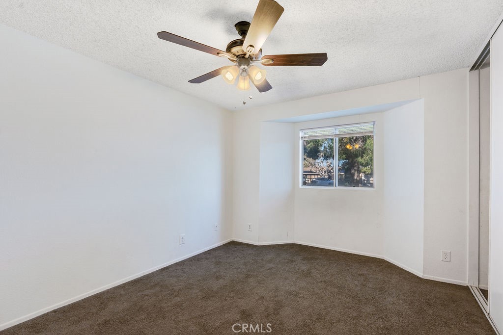 7365 Chase Hesperia, CA 92345 - Photo 14 of 21 an empty room with a window and a fan