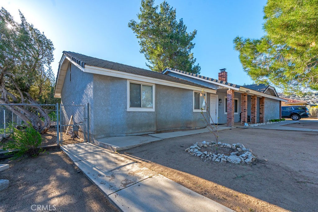 7365 Chase Hesperia, CA 92345 - Photo 2 of 21 a front view of a house with garden