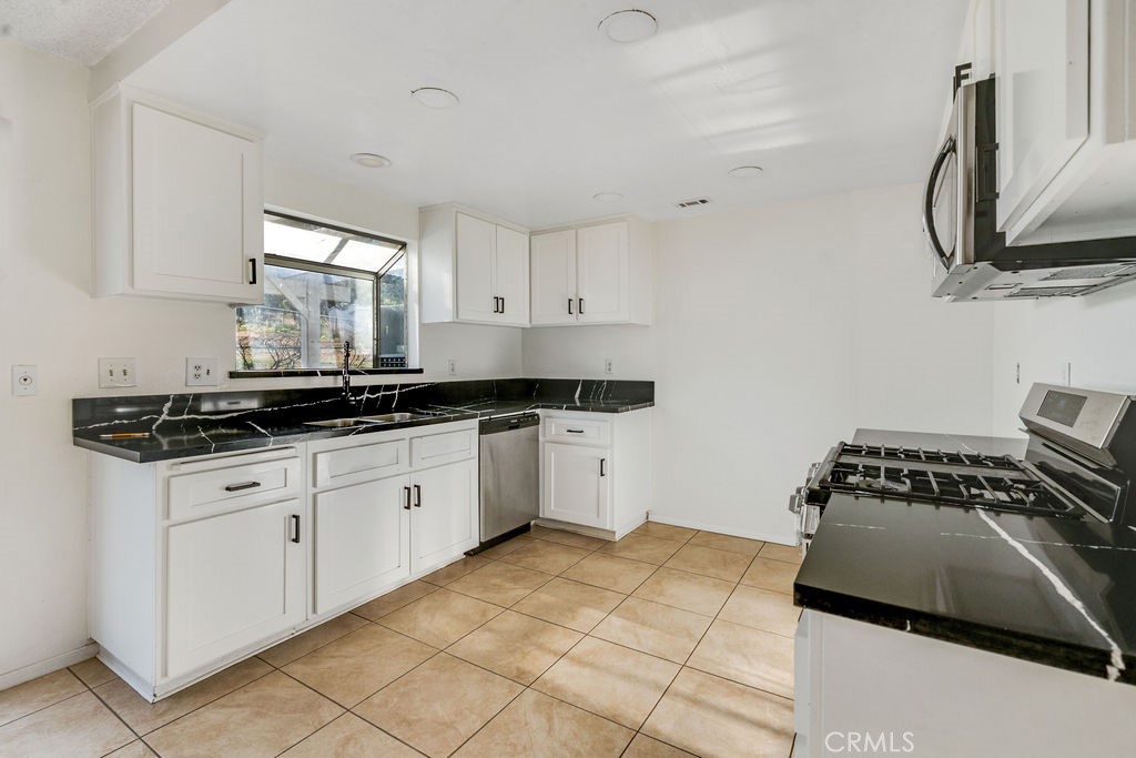 7365 Chase Hesperia, CA 92345 - Photo 6 of 21 a kitchen with a sink and cabinets