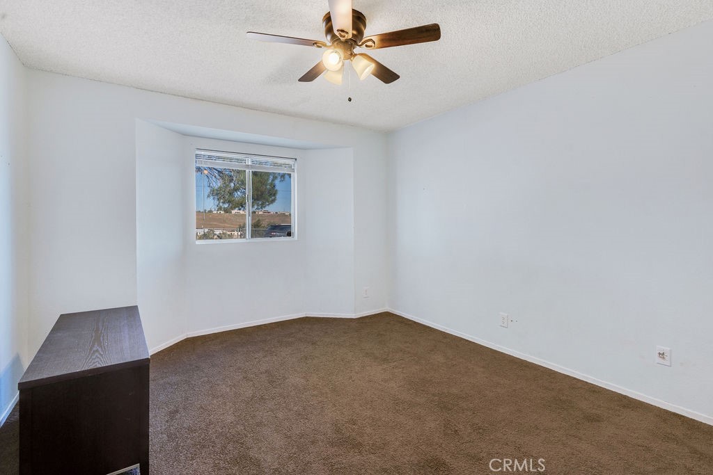 7365 Chase Hesperia, CA 92345 - Photo 9 of 21 an empty room with a window and a fan