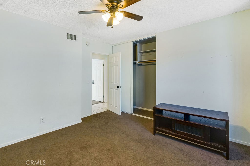 7365 Chase Hesperia, CA 92345 - Photo 10 of 21 a view of room with hardwood floor and ceiling fan