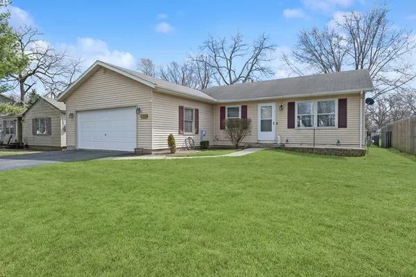 a front view of house with yard and green space