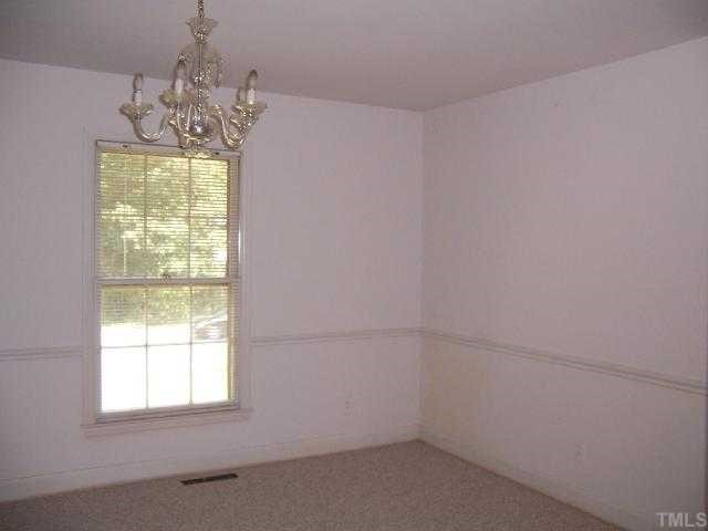 2501 10th Avenue Raleigh, NC 27612 - Photo 4 of 12 a bathroom with a window and a chandelier