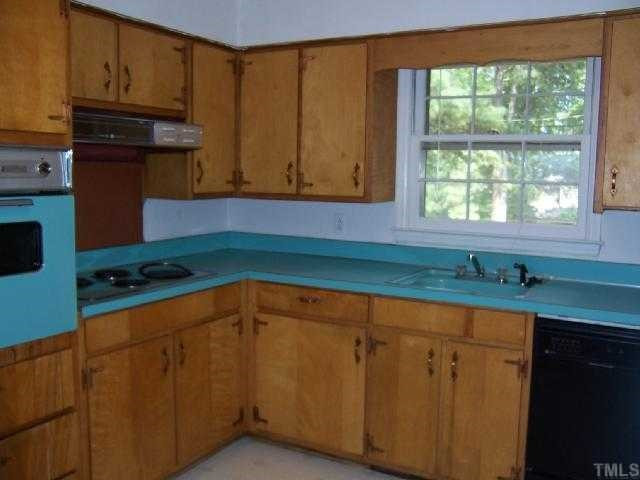 2501 10th Avenue Raleigh, NC 27612 - Photo 5 of 12 a kitchen with wooden cabinets and a sink