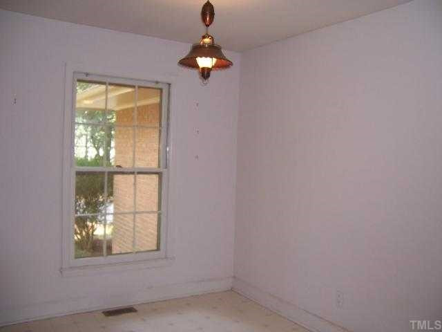 2501 10th Avenue Raleigh, NC 27612 - Photo 6 of 12 an empty room with a window