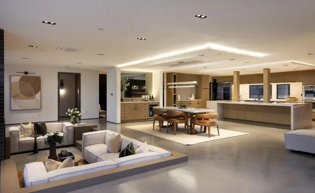 a living room with furniture and view of kitchen