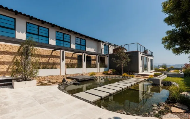 a view of a house with swimming pool and sitting area