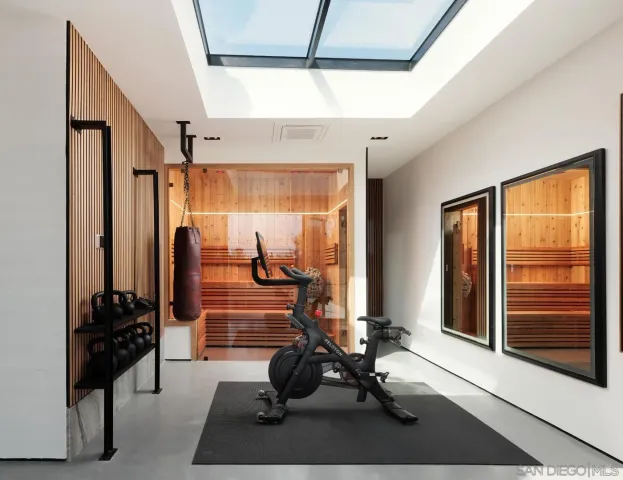 a room with gym equipment and large window