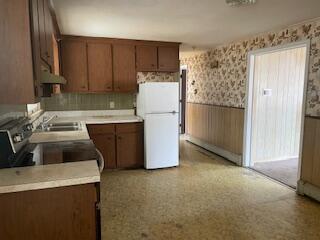 359 Great Western Road Harwich, MA 02645 - Photo 2 of 16 a kitchen with a refrigerator sink stove and cabinets
