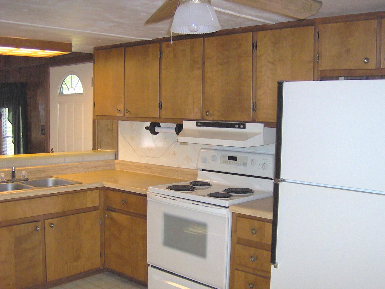 2209 Parrish Road Goodview, VA 24095 - Photo 4 of 9 a kitchen with a stove cabinets and a sink