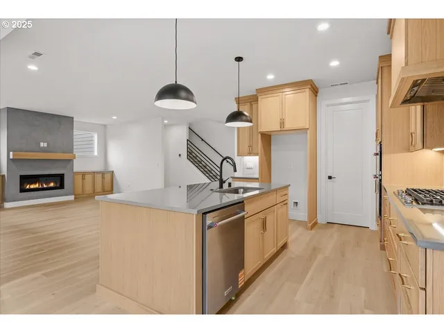 a kitchen with stainless steel appliances granite countertop a stove and a refrigerator