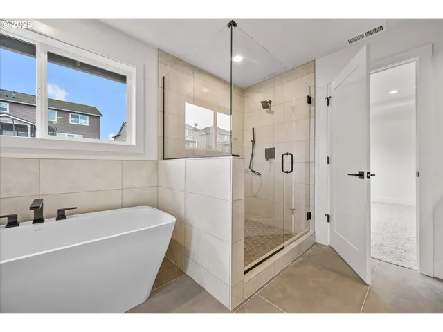 a bathroom with a bathtub and a shower