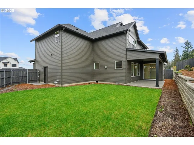 a front view of a house with a garden and yard