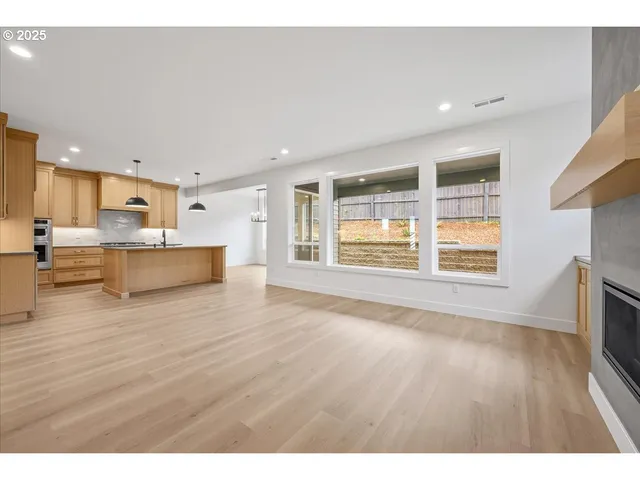 a view of kitchen with wooden floor and windows
